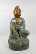 A Chinese green crackle glazed pottery Quan Yin with a gilt face and extremities, 19½" high