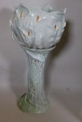 An Art Nouveau style pottery jardiniere on stand of embossed organic form decorated with embossed