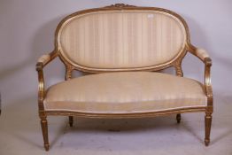 A C19th Continental giltwood canape, with watergilt highlights and serpentine front, 52" x 40"