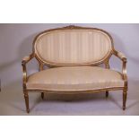 A C19th Continental giltwood canape, with watergilt highlights and serpentine front, 52" x 40"