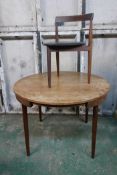 A Danish mid century teak dining table, 42" diameter, raised on screw in tapering supports,