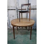 A Danish mid century teak dining table, 42" diameter, raised on screw in tapering supports,