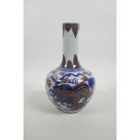 A Chinese blue and white porcelain bottle vase with fo dog decoration highlighted with red, 4