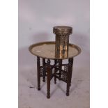 An Egyptian brass tray top table on a turned wood collapsible base, together with a Middle Eastern