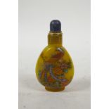 A yellow Peking glass snuff bottle with enamelled dragon and phoenix decoration, 3½" high