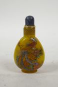 A yellow Peking glass snuff bottle with enamelled dragon and phoenix decoration, 3½" high
