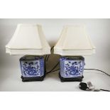 A pair of blue and white decorative Chinese ceramic lamps on wooden stands, 18" high x 12" wide,