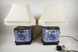 A pair of blue and white decorative Chinese ceramic lamps on wooden stands, 18" high x 12" wide,