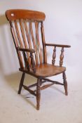 A C19th Windsor elbow chair with elm seat