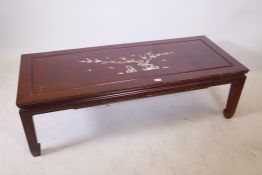 A Chinese hardwood coffee table with inlaid mother of pearl decoration of birds and a prunus tree,