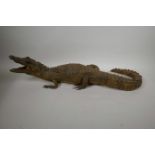 A C19th taxidermy stuffed figure of a crocodile in naturalistic pose, 27" long