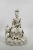 A Chinese blanc de chine Quan Yin seated on an elephant, impressed marks verso, 13" high