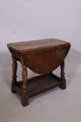 An oak swivel top dropleaf occasional table on turned supports united by an undertier, 19½" x 11",