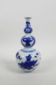 A Chinese blue and white porcelain triple gourd vase decorated with flowers and objects of virtue, 4