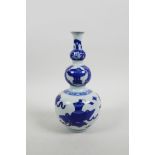 A Chinese blue and white porcelain triple gourd vase decorated with flowers and objects of virtue, 4