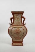 A Chinese red and white pottery two handled vase with decorative panels depicting dragon, 12" high