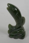 A small carved jade figurine of a leaping salmon, 3¼" long