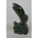 A small carved jade figurine of a leaping salmon, 3¼" long