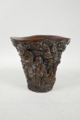 A Chinese faux horn libation cup with carved decoration of the Eight Immortals, 4 character mark