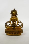 A Sino-Tibetan gilt bronze of Buddha seated on a lotus throne, impressed double vajra mark to