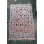 A Persian hand knotted carpet, with geometric designs on a terracotta field, with inscription, 72" x
