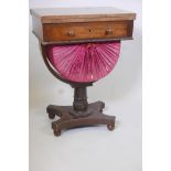 A Regency rosewood pedestal work table with rising top frieze drawer and fabric covered basket on