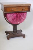 A Regency rosewood pedestal work table with rising top frieze drawer and fabric covered basket on