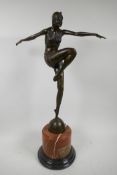 An Art Deco style bronze figurine of a dancing girl on a rouge marble socle, 22" high