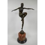 An Art Deco style bronze figurine of a dancing girl on a rouge marble socle, 22" high