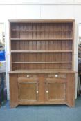 A large Irish pine kitchen dresser with open shelves over two drawer and cupboard base, 80" high,