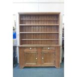 A large Irish pine kitchen dresser with open shelves over two drawer and cupboard base, 80" high,