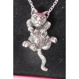 A silver articulated pendant in the form of a cat on a silver chain