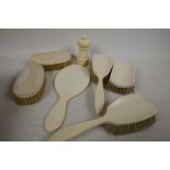 An early C20th ivory backed dressing table set of hand mirror and five brushes, together with an