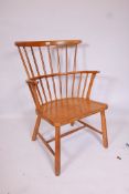 A mid C20th beechwood comb back elbow chair