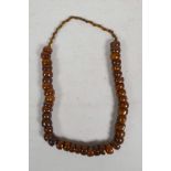 A string of amber style beads, 24" long