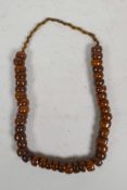 A string of amber style beads, 24" long