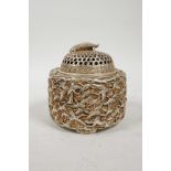 A Chinese white metal cylinder censer and cover, the side decorated with many storks in flight and