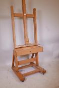 A Mabef artist's studio easel on castors, lacks winder, 90" high