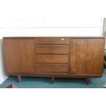 A mid century teak sideboard in two sections comprising four drawers flanked by cupboards, one