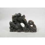 A Chinese carved green hardstone ornament in the form of a dragon, 9" long, losses