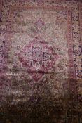 An antique hand woven silk Kashan carpet with central medallion and blue borders, 55" x 86"