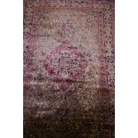 An antique hand woven silk Kashan carpet with central medallion and blue borders, 55" x 86"