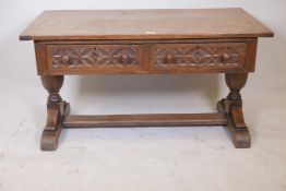An oak plank top refectory coffee table having two frieze drawers and turned pedestal supports,