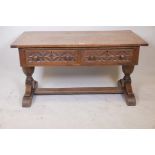 An oak plank top refectory coffee table having two frieze drawers and turned pedestal supports,