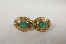 A pair of oval yellow 14ct gold emerald and diamond earrings