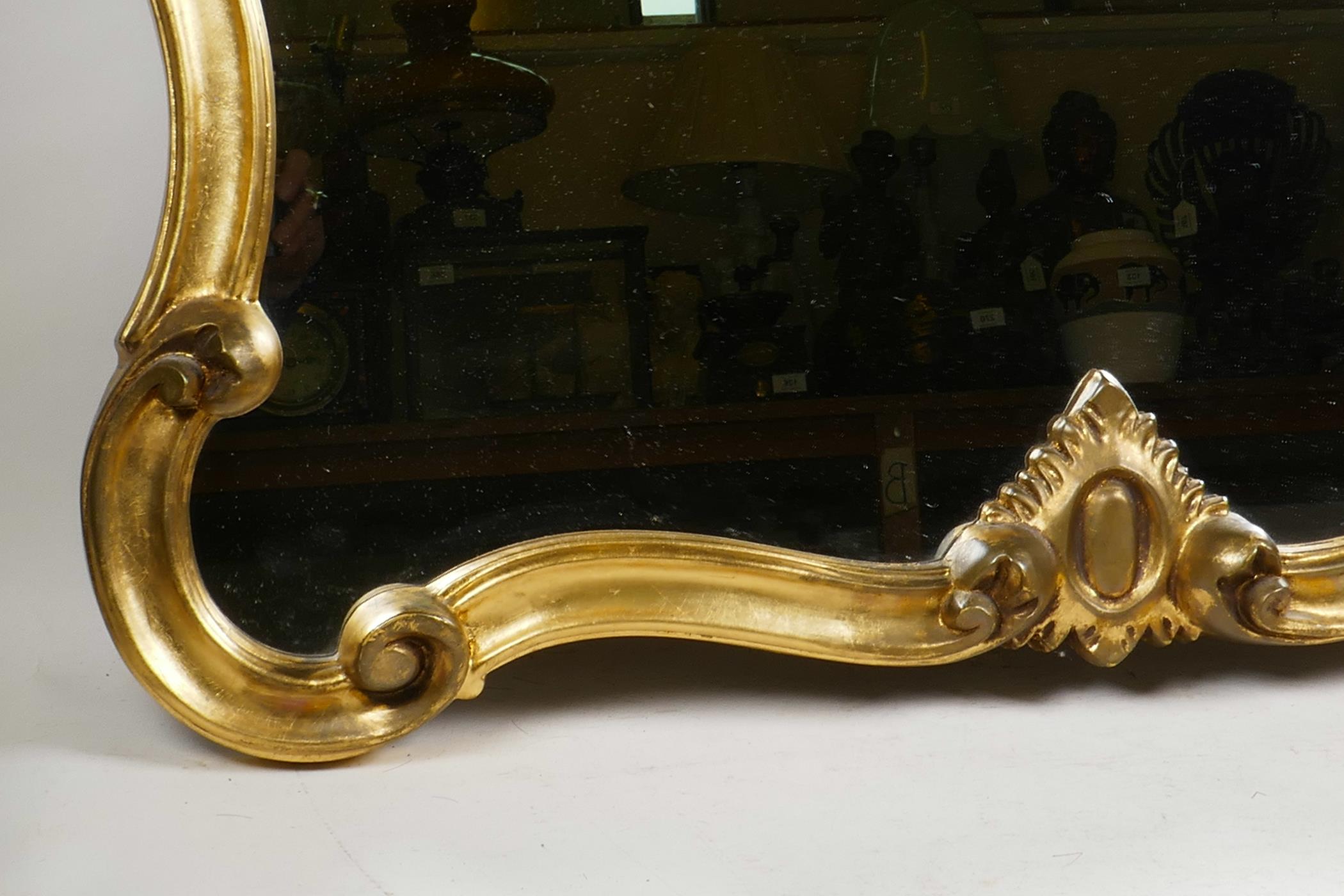 An elaborate Rococo style mirror with a gilded scrolling frame, in good condition, 32" wide x 70" - Image 4 of 7