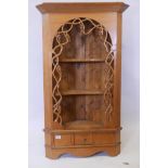 A pine hanging corner shelf with pierced grape and vine decoration and single drawer, 49" x 29"