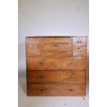 A late C19th camphorwood campaign chest in two sections, the top half fitted with a fall front