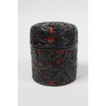 A C19th Chinese carved cinnabar red and black lacquer stacking trinket box, in three sections,