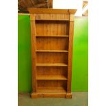 A pine open bookcase with fixed shelves and reeded frieze and front, 40" x 11" x 68"